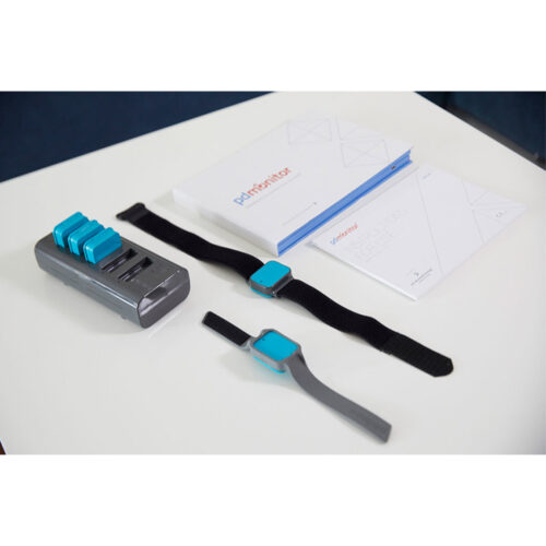 A flat lay of the separate components of the Parkinson’s disease monitor on a table.