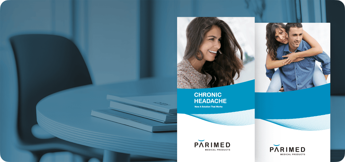 In the background, a table has brochures on it, and in the foreground, a close-up of two brochures.