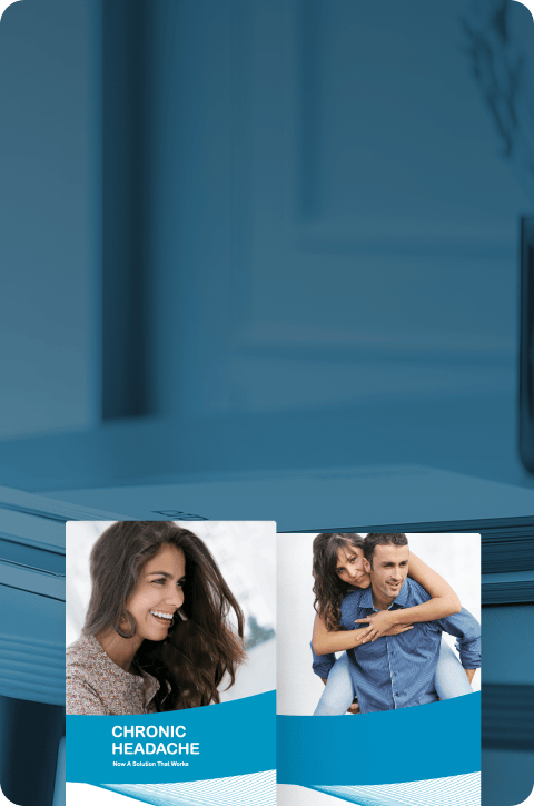 In the background, a table has brochures on it, and in the foreground, a close-up of two brochures.